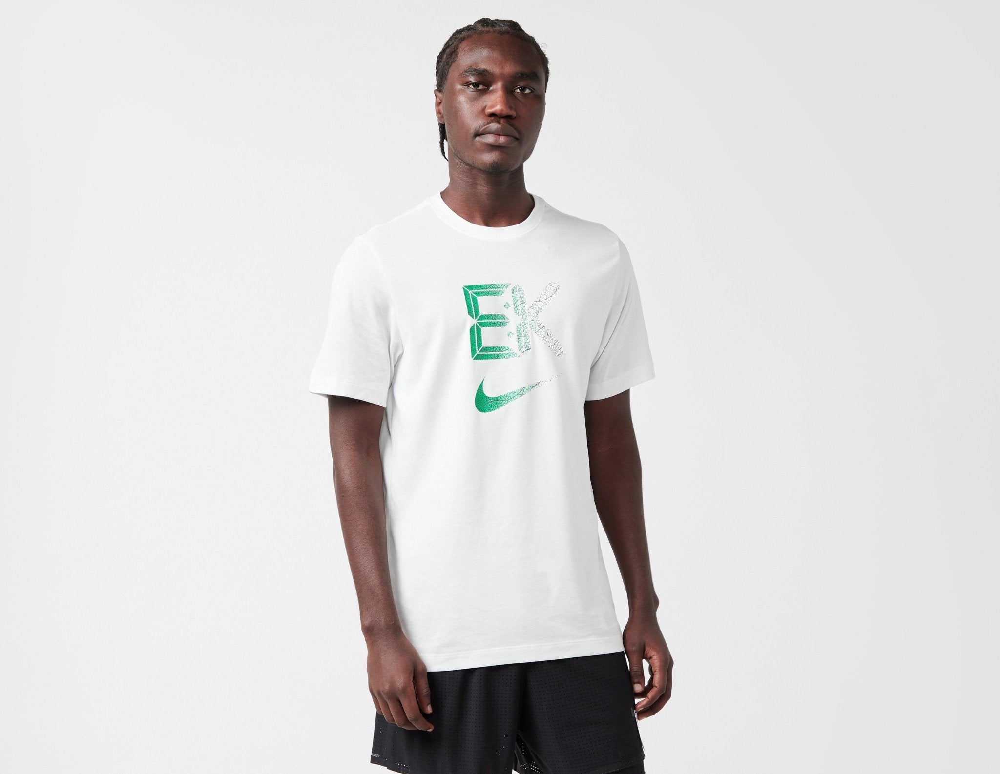 white nike shirt with green swoosh
