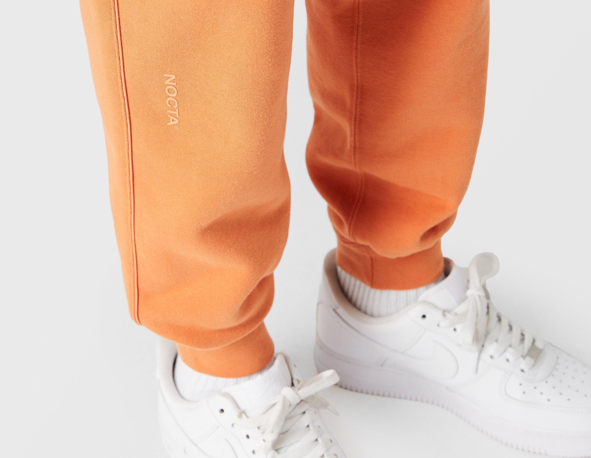 orange joggers nike